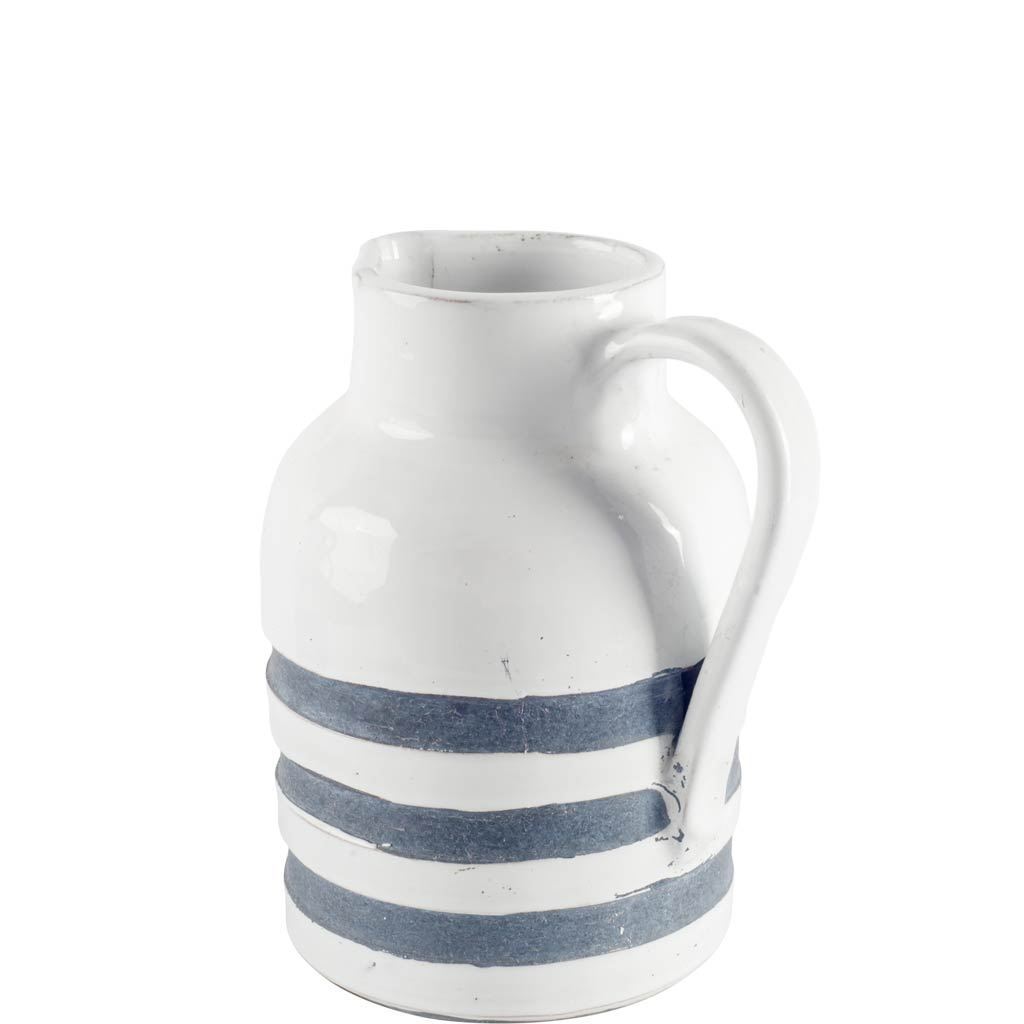 This vase is designed to look like a rustic weathered water pitcher with pouring handle and horizontal blue stripes.